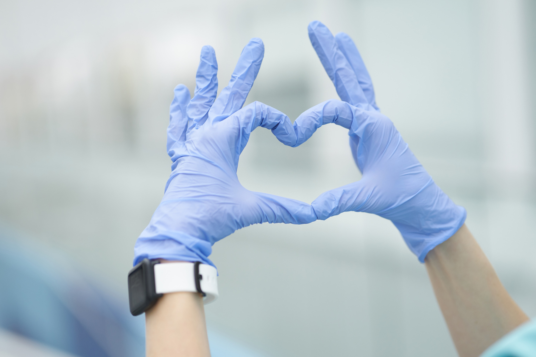 Heart sign made by medicine gloves covered hands. Love medicine concept
